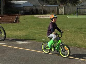 Joseph practicing his bike skills so he will be ready to ride on the pump track
